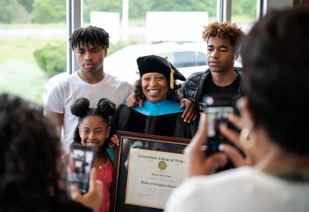 Student graduating with degree surrounded by family Home  